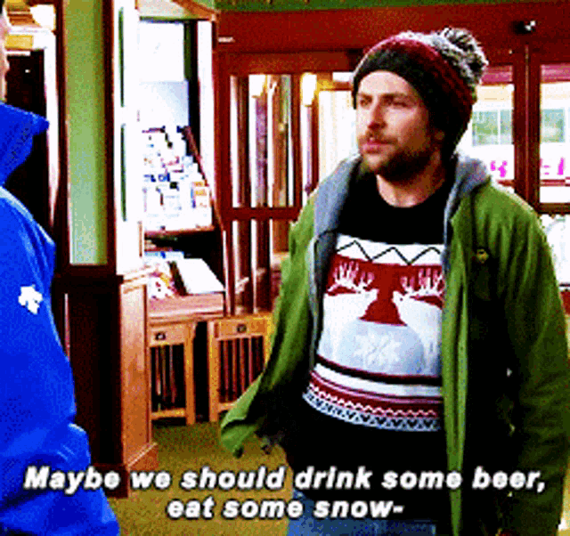 a man wearing a sweater that says maybe we should drink some beer