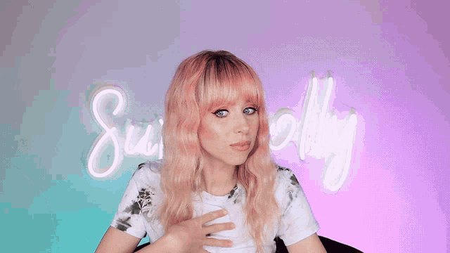 a woman with pink hair is standing in front of a neon sign that says ' su molly '