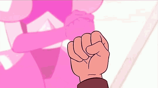 a close up of a person 's fist in front of a pink cartoon character .