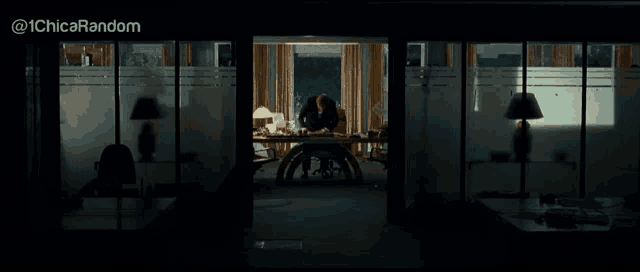 a man is sitting at a desk in a dark room with the hashtag @ 1chica random