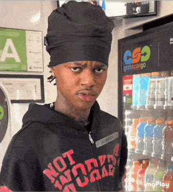 a man wearing a black hoodie that says " not work "