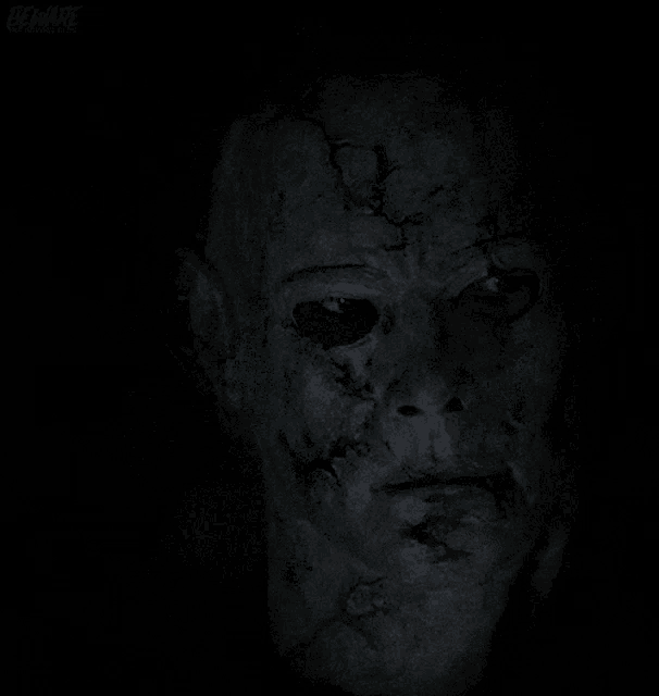 a close up of a person 's eye in the dark with a blurred background