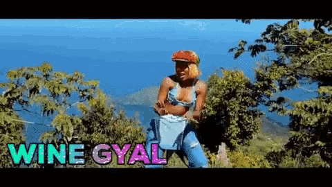 a woman in a bikini is standing in a field with the words wine gyal on the bottom