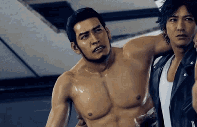 a shirtless man in a video game is being held by another man .