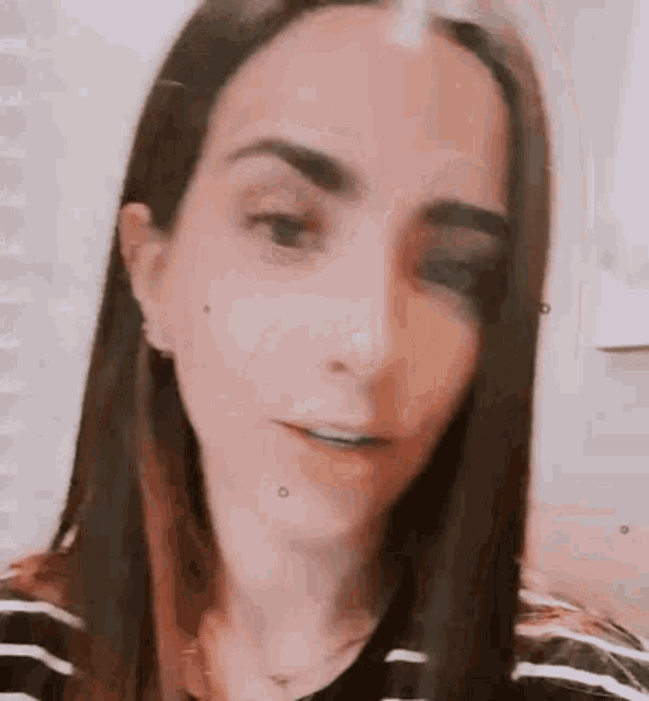 a close up of a woman 's face with long hair .