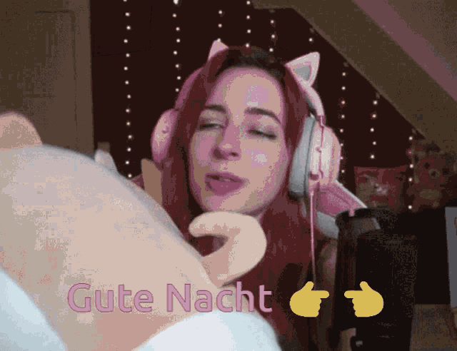 a woman wearing pink headphones says " gute nacht " in pink