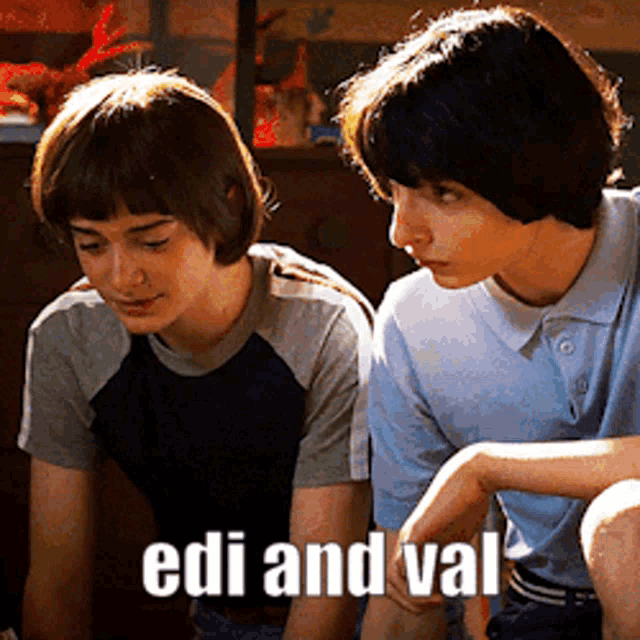 two boys are sitting next to each other and the words edi and val are on the bottom of the picture