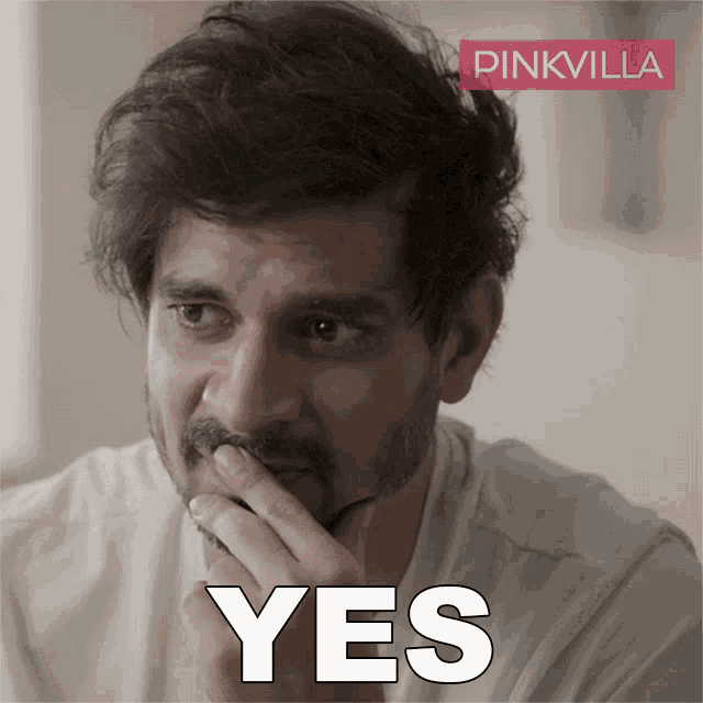 a man with a beard covering his mouth with his hand and the word yes written in white