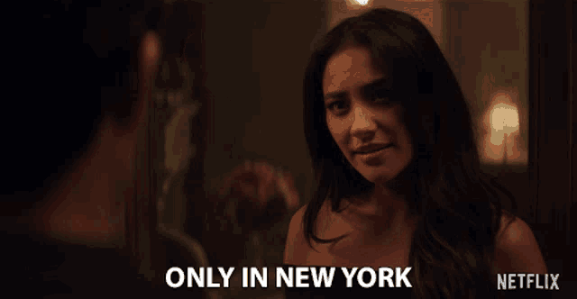 a woman talking to a man with the words only in new york on the bottom