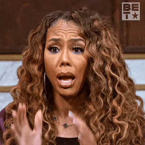 a woman with a surprised look on her face is standing in front of a sign that says bet