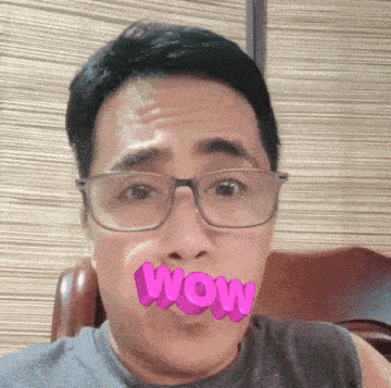 a man with glasses has the word wow written on his mouth