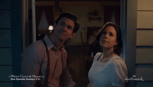 a man and a woman are standing in front of a house with the words when calls the heart on the bottom