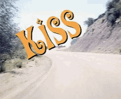 a road with the word kiss written on it
