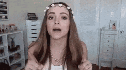 a woman is wearing a flower crown on her head .