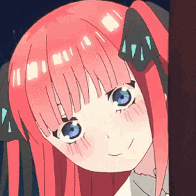 a close up of a girl 's face with pink hair and blue eyes