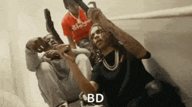 a group of men are sitting on a staircase holding guns and one of them is holding a gun .