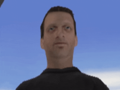 a man in a black shirt is looking at the camera with a blue sky in the background