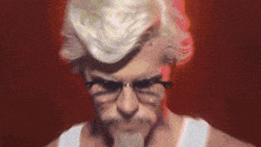 a close up of a man wearing glasses and a wig