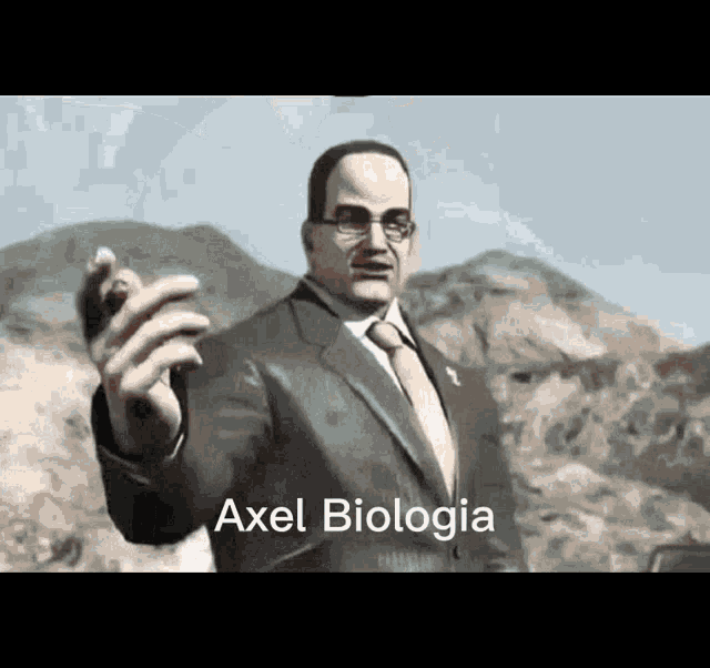 a man in a suit and tie is pointing at something with the words axel biologia written on the bottom .