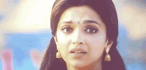 a close up of a woman 's face with a tear running down her face .