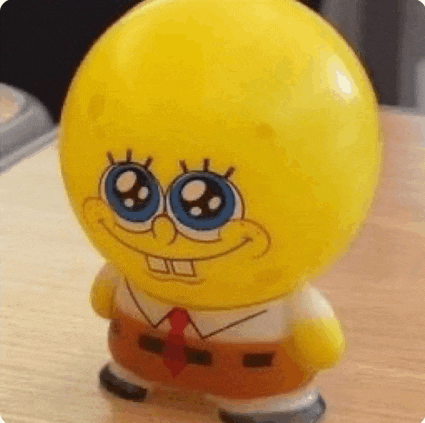 a toy of spongebob squarepants is sitting on a wooden table .