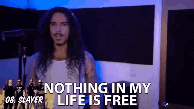 a man with long hair and a mustache says nothing in my life is free in front of a slayer band