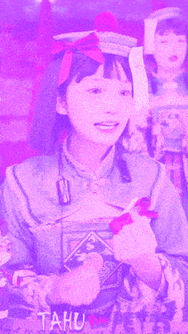 a girl in a purple outfit with the word tahu on the bottom right