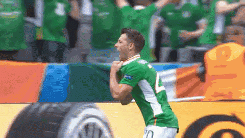 a man in a green jersey with the number 10 on the back