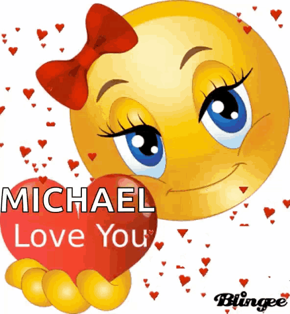 a smiley face with a red bow on it holding a heart that says michael love you