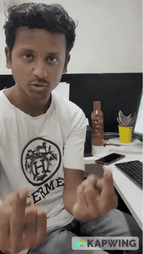 a man wearing a white shirt that says " hermes " on it