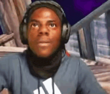 a man wearing headphones and a scarf is looking up at the camera .