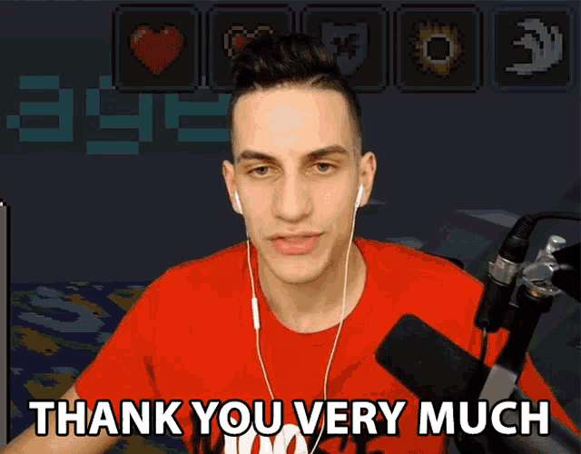 a man wearing headphones says thank you very much in front of a microphone