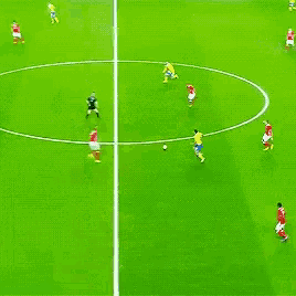 a group of soccer players playing on a field