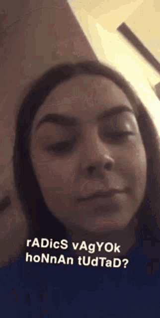 a close up of a woman 's face with the words " radics vagyok honnan tudtad " at the bottom