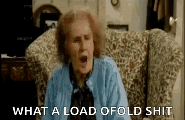 a woman is sitting in a chair with her mouth open and screaming .