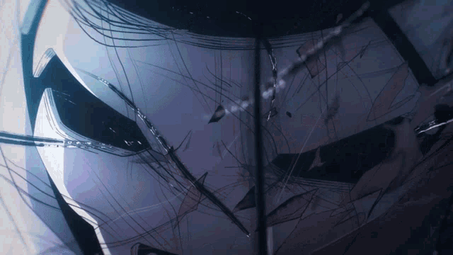 a close up of a broken glass window with a reflection of a person