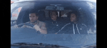 three men are sitting in a car and one of them is wearing an adidas sweatshirt .