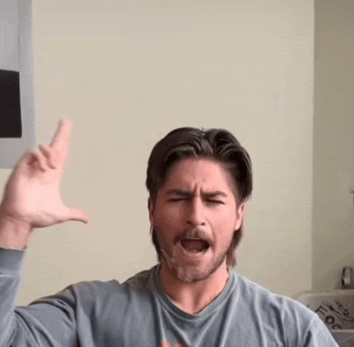 a man with a beard is making a funny face