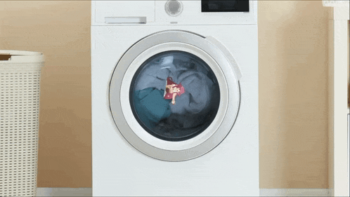 a white washing machine with clothes in it and a doll in it