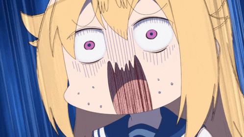a close up of a girl 's face with a surprised look on her face