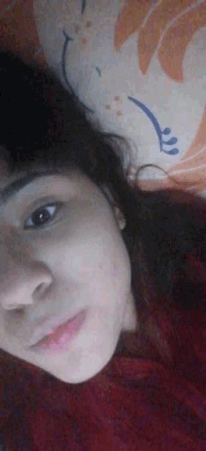 a close up of a woman 's face laying on a blanket