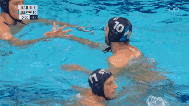 two water polo players hugging in the water with the number 10 on their hats