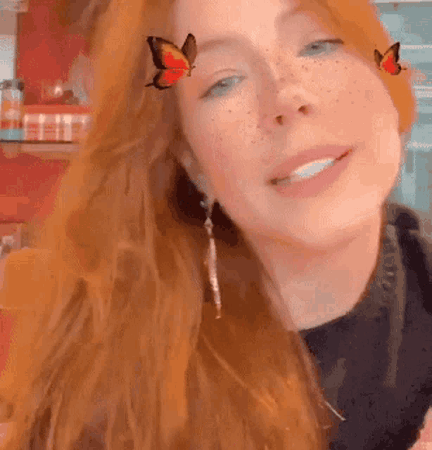 a close up of a woman 's face with a butterfly in her hair