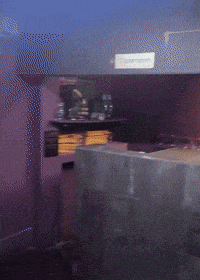 a dark room with a sign on the wall that says ticketroom
