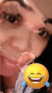 a smiley face with tears coming out of its eyes is next to a woman 's face