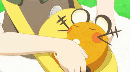a person is holding an orange cartoon character with a cross on it 's head