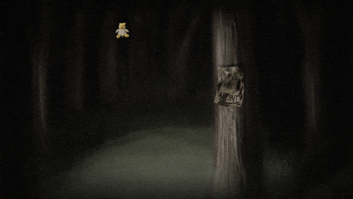a teddy bear is hanging from a tree in a dark forest with a sign that says " i am alone "