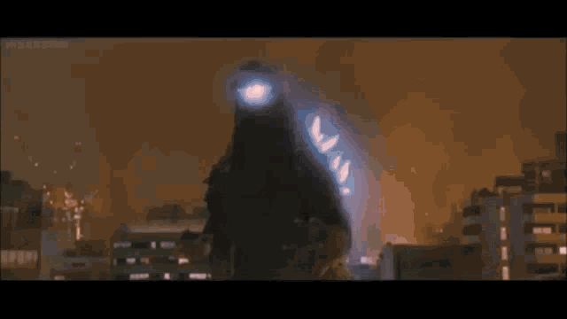 a giant monster is flying through the air in a city .