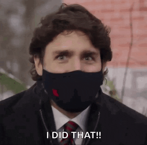 a man in a suit and tie is wearing a face mask and says `` i did that '' .