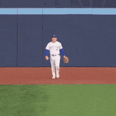 a baseball player wearing a white jersey with the name tate on the back